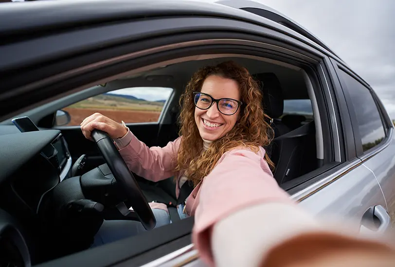 smiling woman in new car